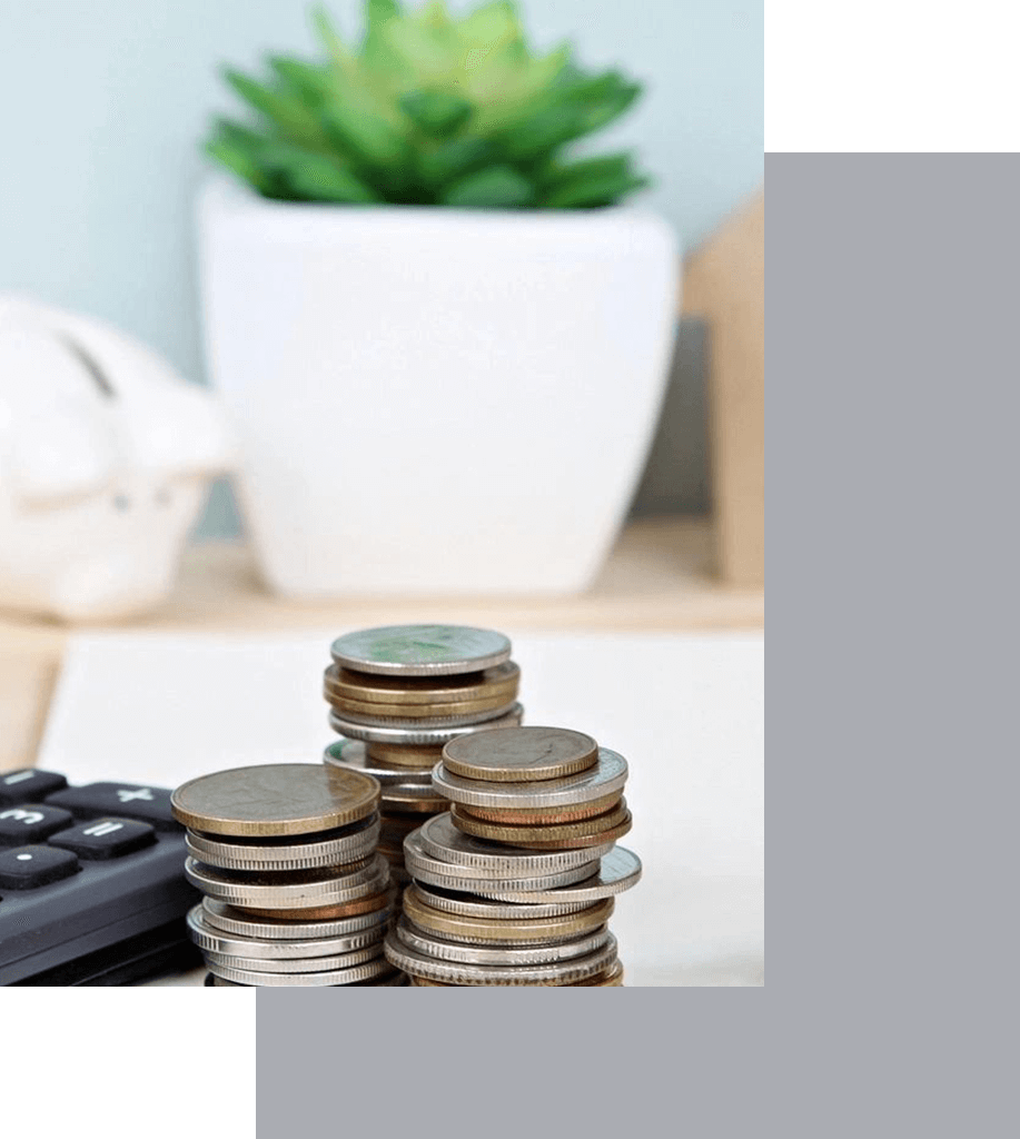 A stack of coins next to a calculator.