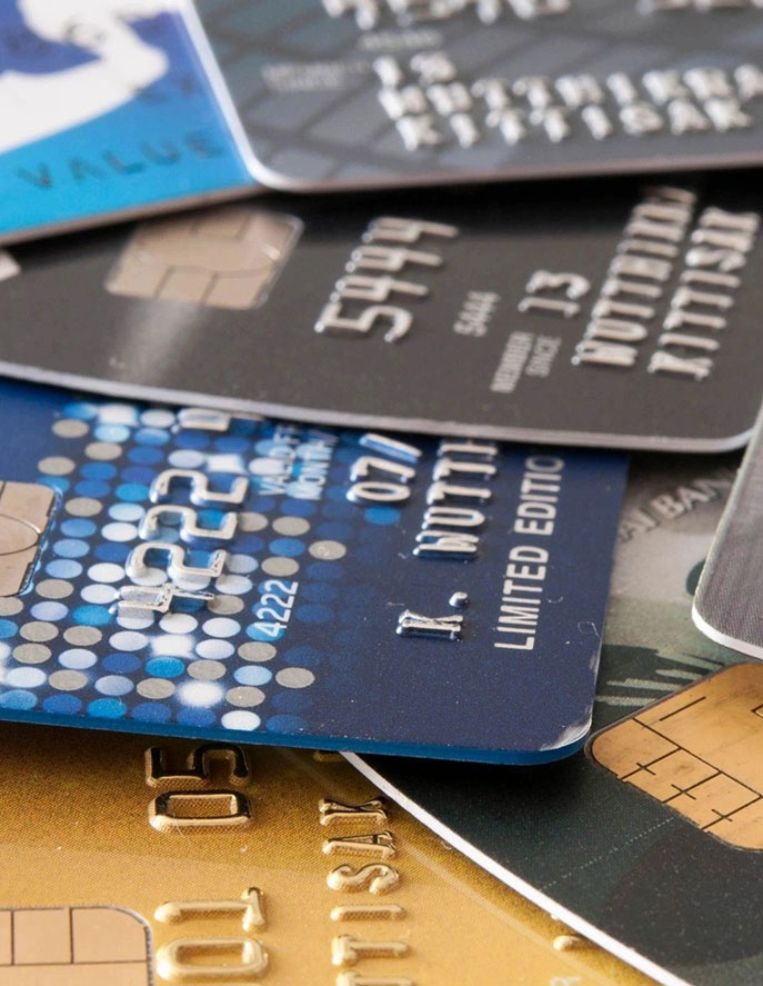 A close up of several credit cards on top of each other.